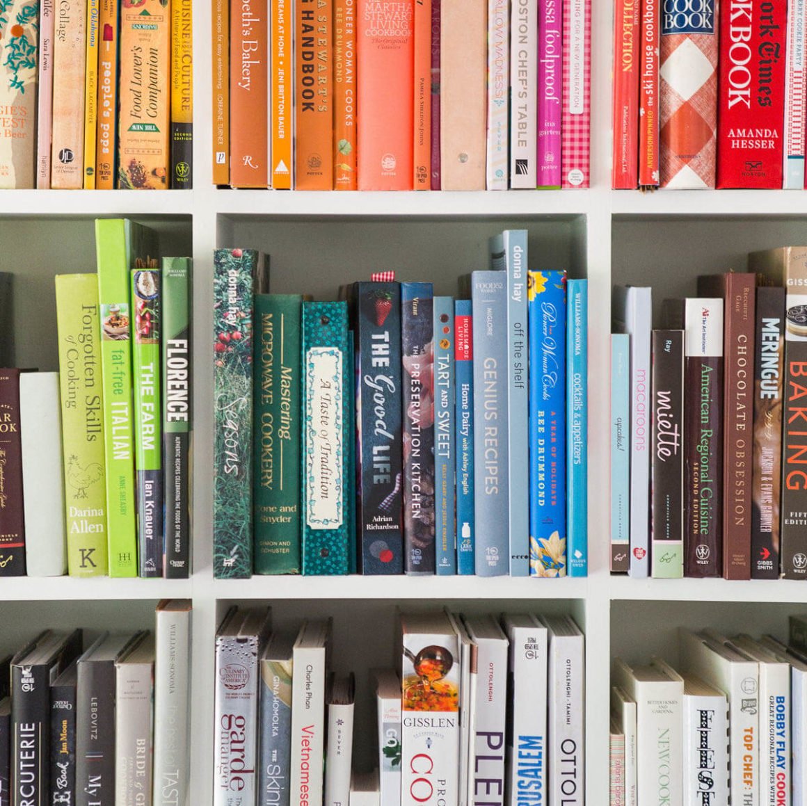 colorful books in rainbow order on a shelf