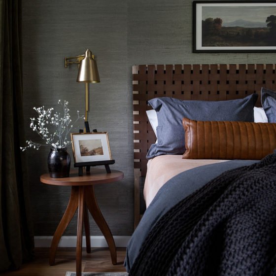 moss green bedroom with dark colored furnishings