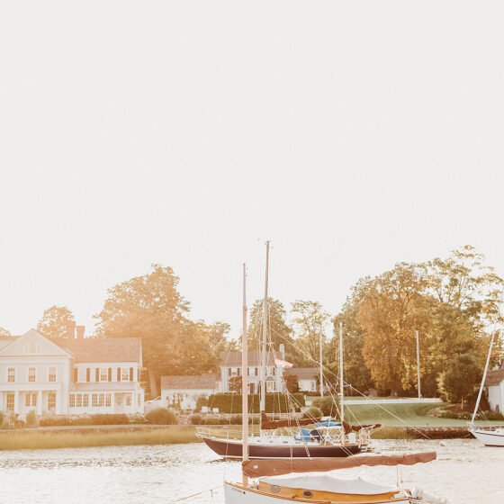 sailboats on the river in setting sun