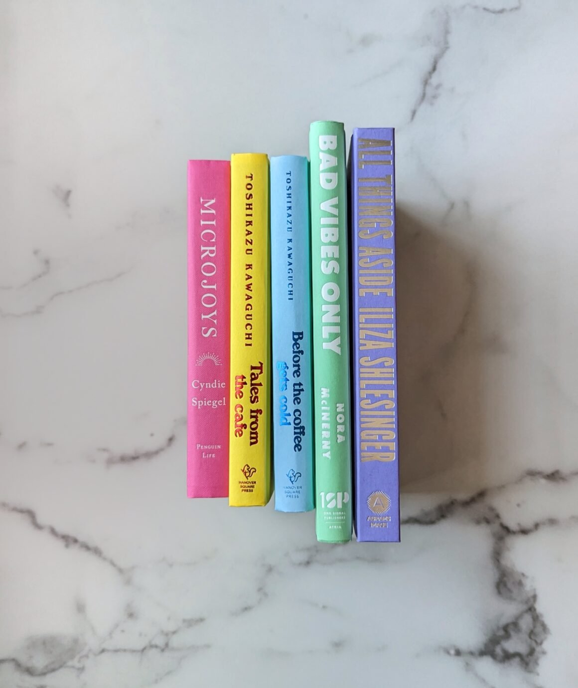 latest books I read, a stack of 5 rainbow colored books