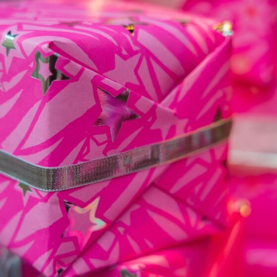 holiday gift wrapped in hot pink wrapping paper
