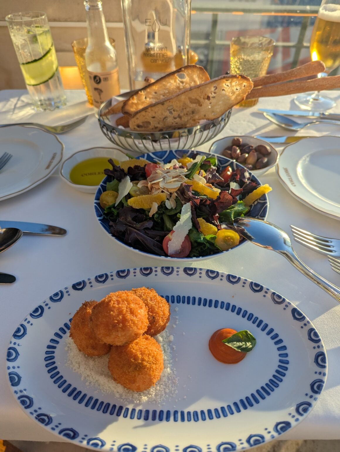arancini, bread basket, and side green salad at Corleone in Cascais