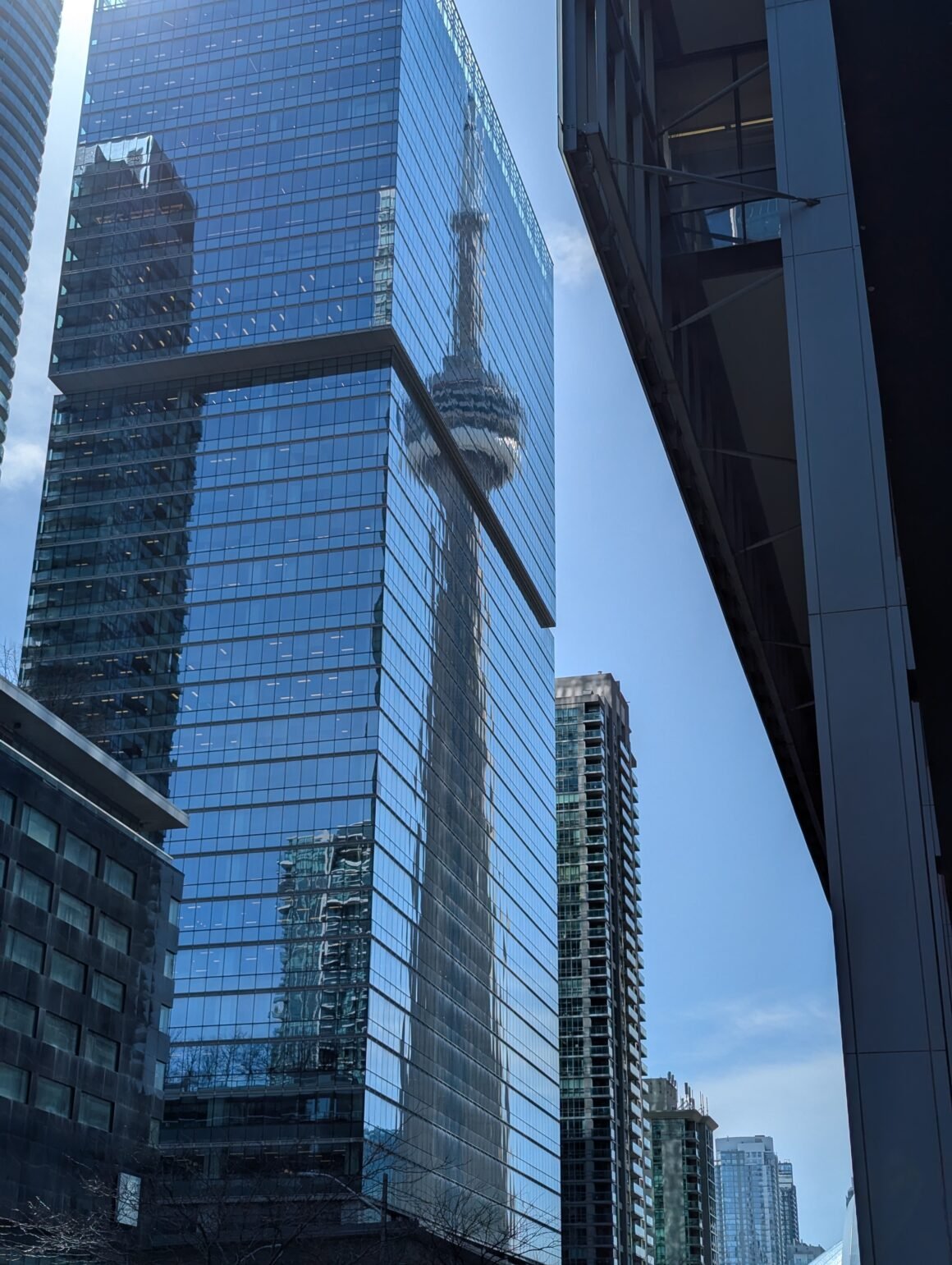 CN Tower reflection on buildings in downtown Toronto, Canada