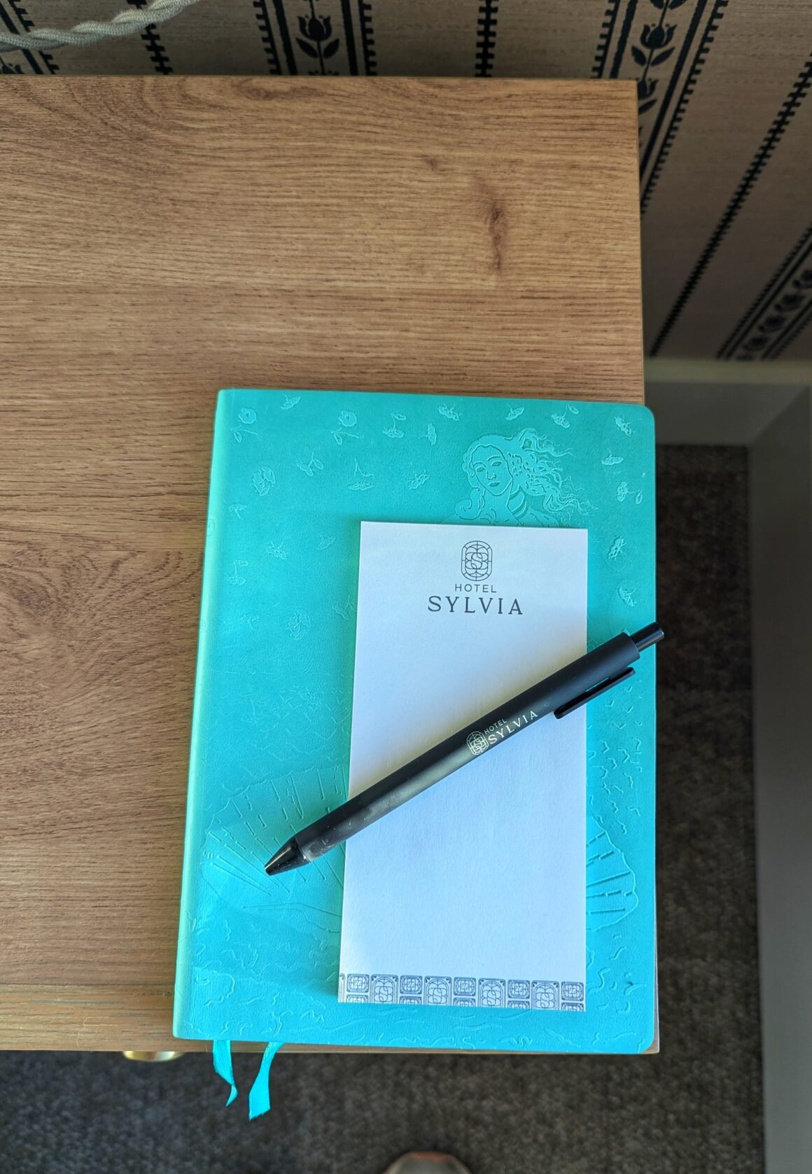 journal and note pad on nightstand